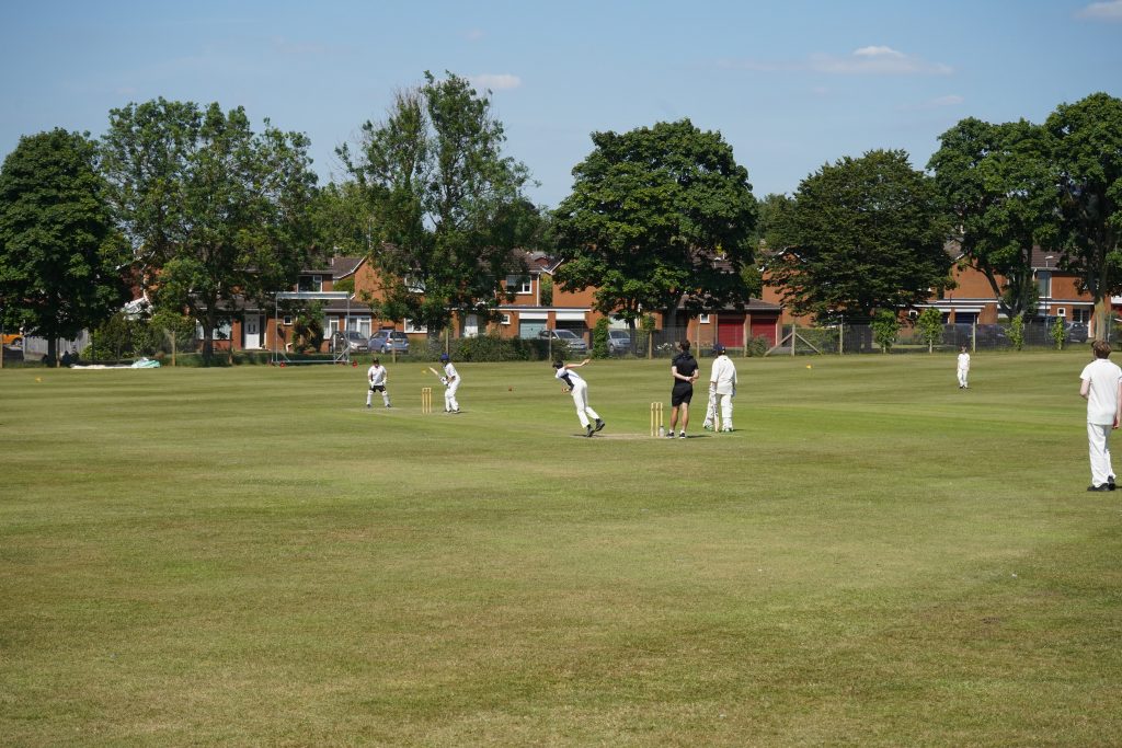 Students playing cricket