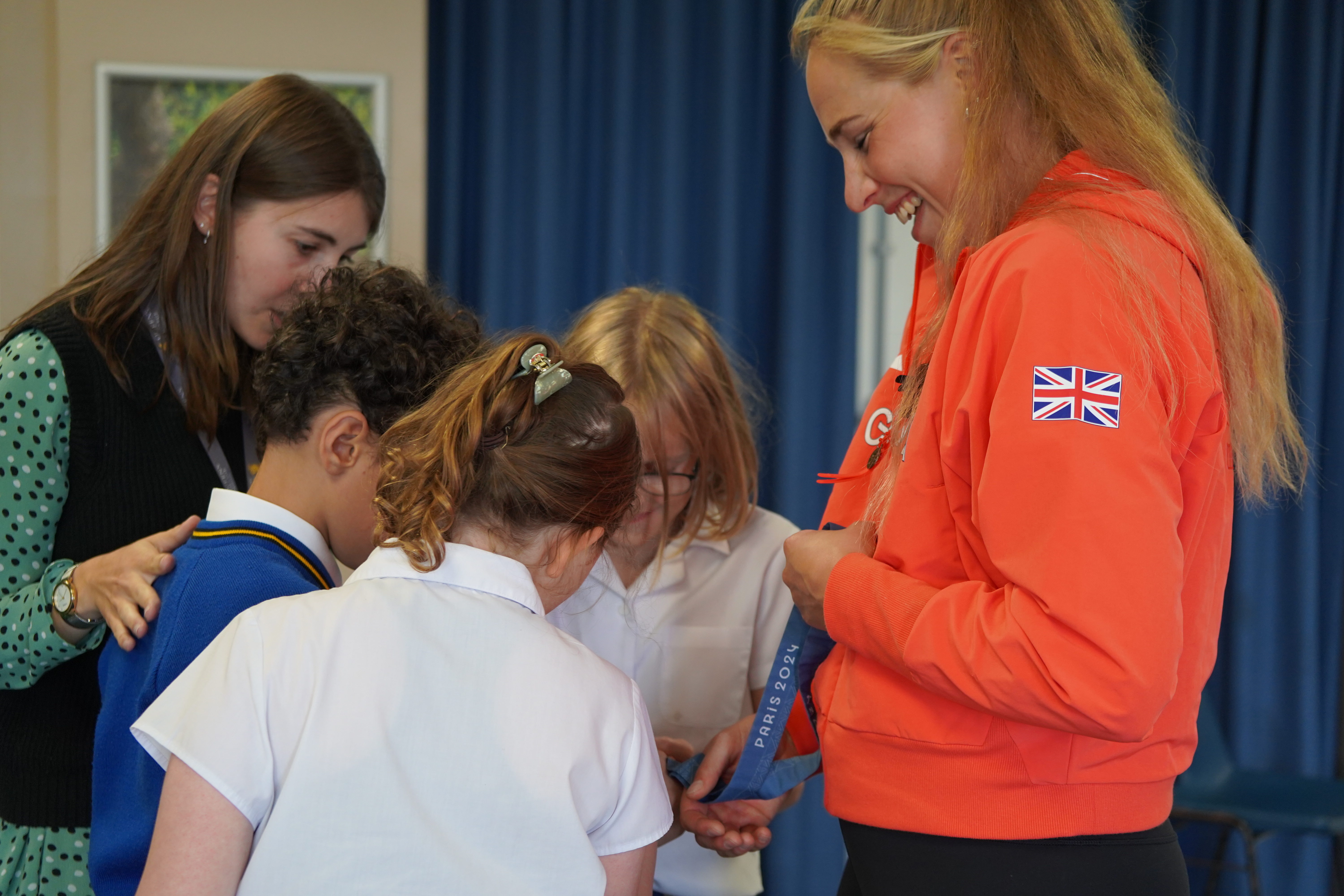 Olympian Rebecca Wilde shows her Bronze Medal to Prep School Students