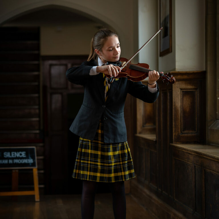 Queen's College pupil playing an instrument