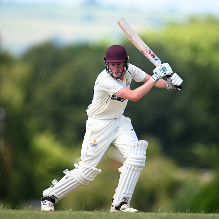 Queen's College pupil playing cricket