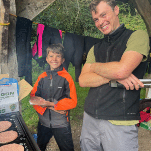 Staff and pupil member cooking.