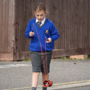 prep school boy playing with a diabolo