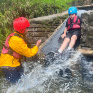 Two pupils playing in the river.