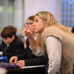 Queen's College teacher helping a pupil