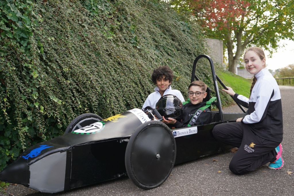Queen's College Taunton's Greenpower Motorsports racing team, showing off their new sponsored kit by Brown & Brown.