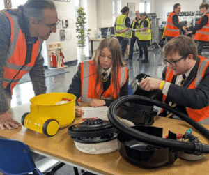 pupils assembling henry vacuums.