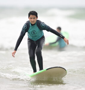Queen's College Taunton pupil surfing