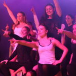 A group of children on stage performing