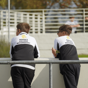 2 pupils watching the race in Brown and Brown sponsored kit.