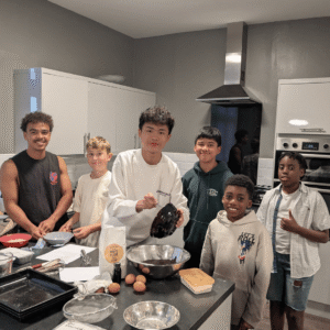 Boys in the School house kitchen cooking.