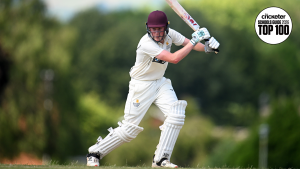 Queen's college player hits the ball for four in cricket match