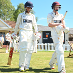 Queen's College batters walk out for cricket match